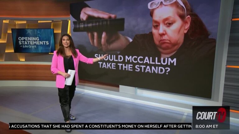 Julie standing on-set with a pic of Beverly McCallum on the monitor.