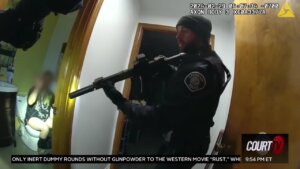 Body cam still of cops busting home invasion suspect on toilet.