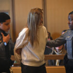 Michelle Troconis is led away in handcuffs in court.