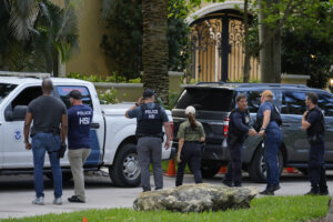 Law enforcement agents stand 