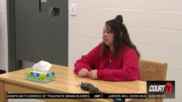 Kayla Montgomery sits at a small wooden table