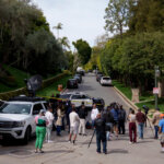 Media gathers as law enforcement blocks a street