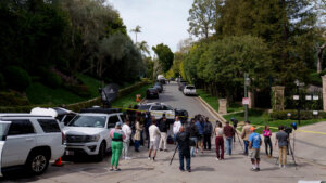 Media gathers as law enforcement blocks a street