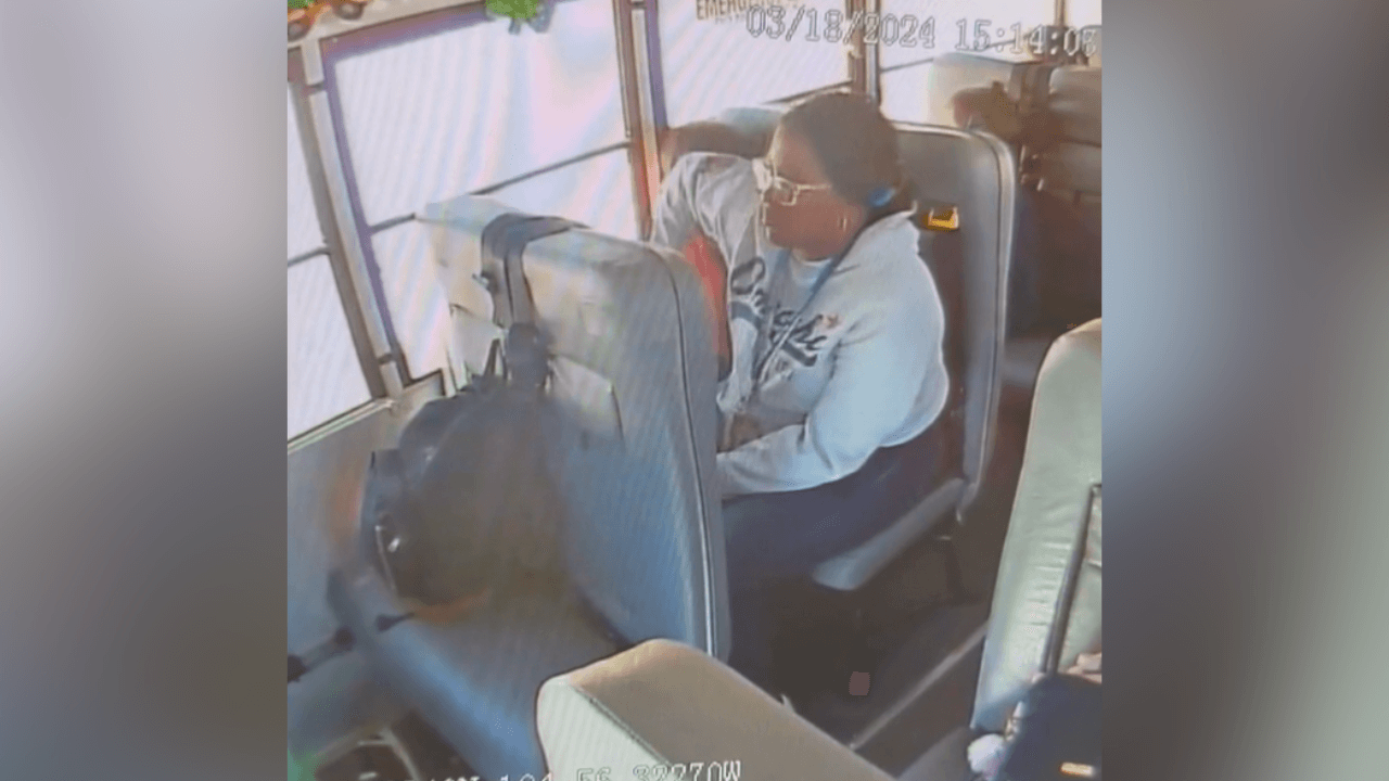 still from surveillance video shows school bus aide elbowing child