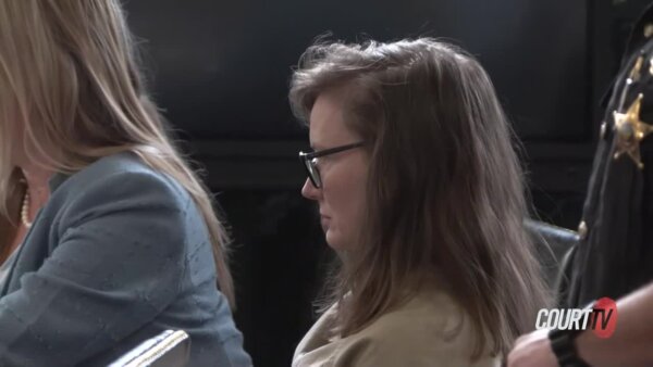 Lisa Nacrelli sits with attorneys at the counsel table in court.