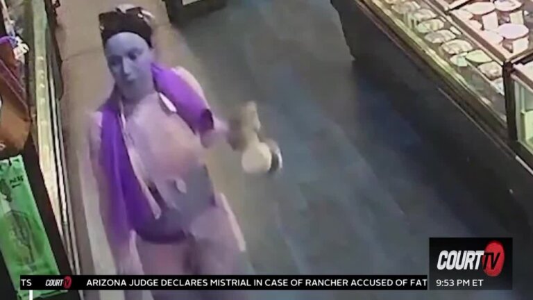 Surveillance footage of woman with a Smurf-like complexion.