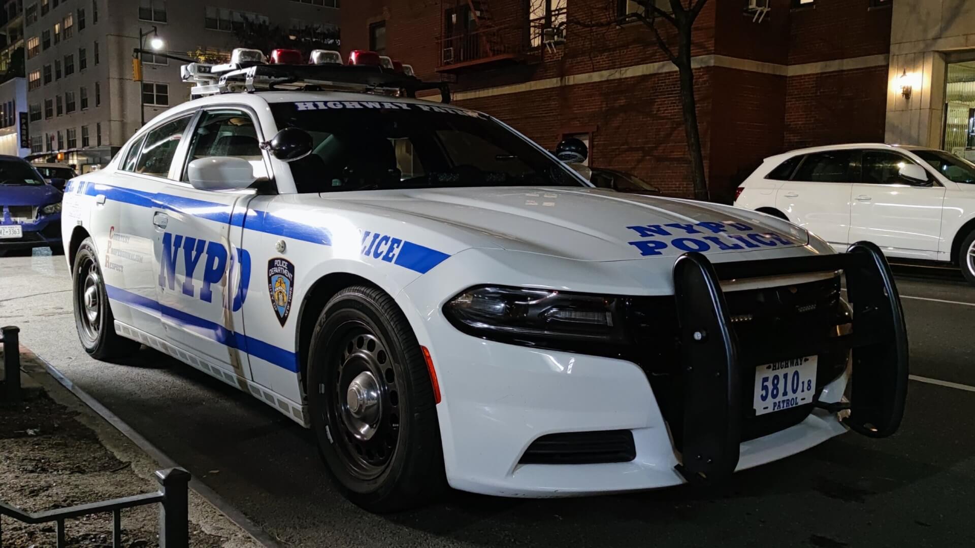 NYPD police cruiser parked on a sidewalk