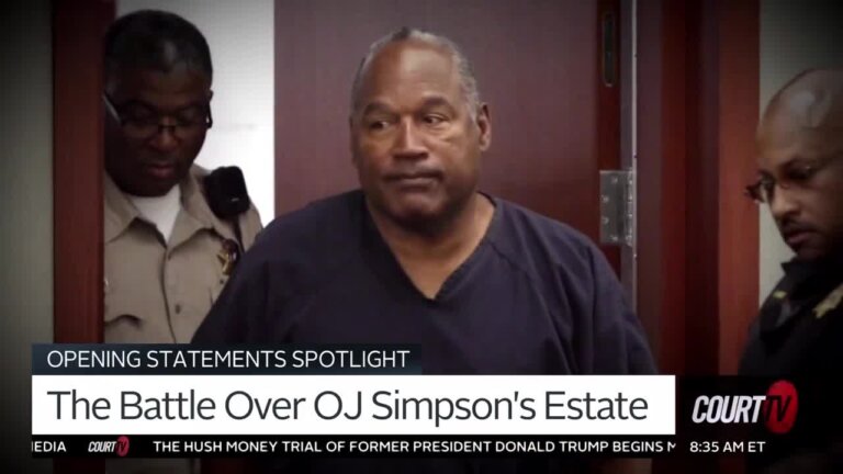 OJ Simpson walks into court wearing a blue prison jumpsuit.