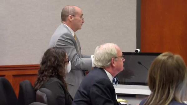 Leilani SImon sits in court with her attorney