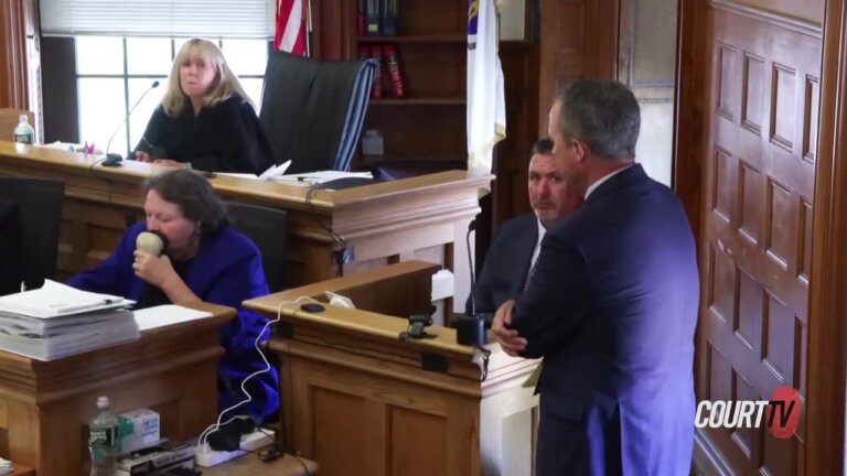 Brian Higgins' attorney confers with him on the stand