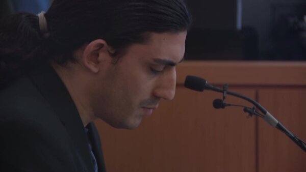 Ali Abulaban looks down as he testifies