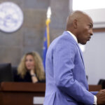 Male attorney presents an argument as female judge looks on.