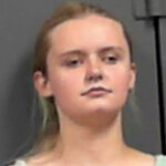 Mug shot of a young, blonde woman.