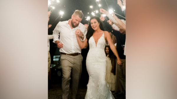 wedding photo shows Aric Hutchinson and Samantha Miller