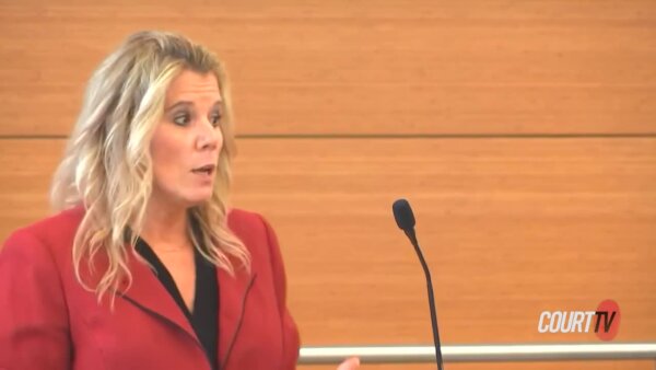 Woman in red coat in court