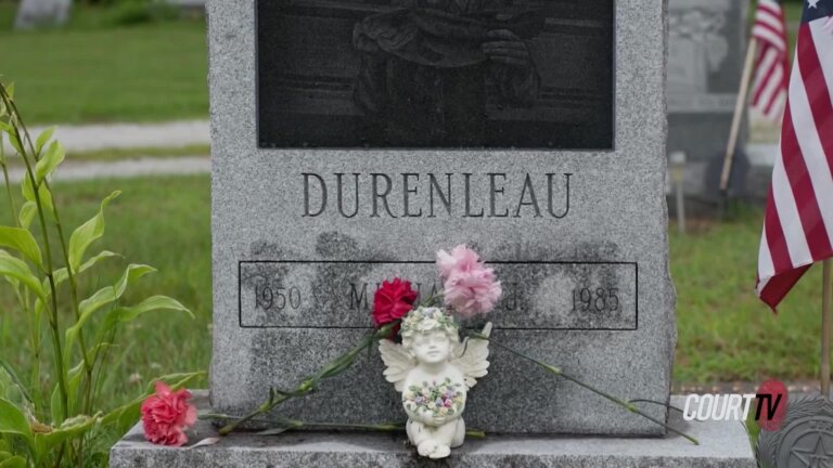 Tombstone with words Durenleau 1950-1985 and small white angel with flowers