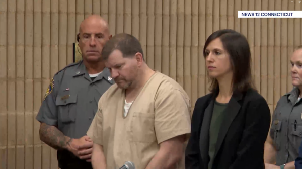 Ewen Dewitt stands in court