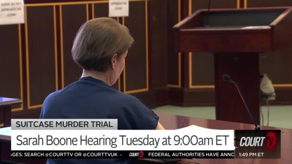 The back of a female defendant's head as she sits in court.