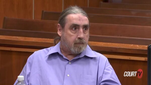 Man in purple shirt in court