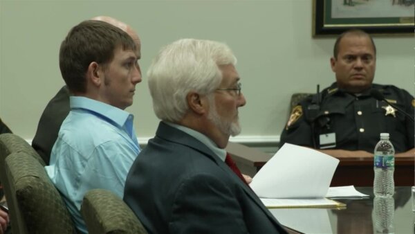 Chad Doerman sits in court with his attorneys