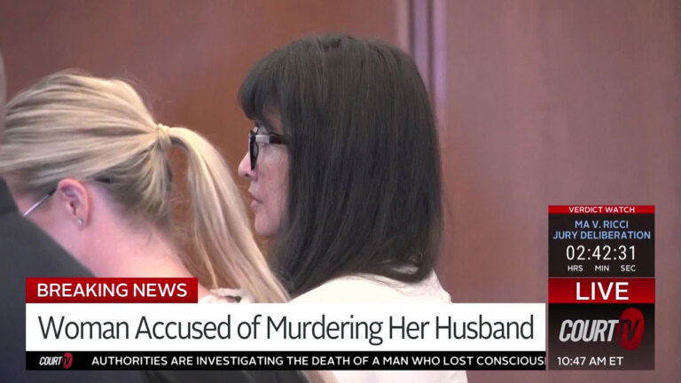 Female defendant wwith long black hair stands and listens as a verdict is read.