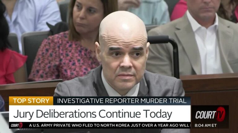 bald man in gray suit in court