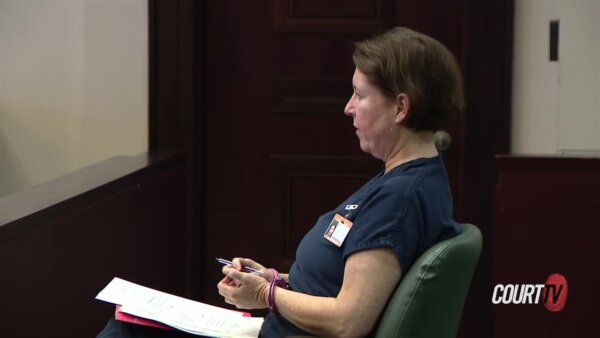 Sarah Boone sits, handcuffed, in court