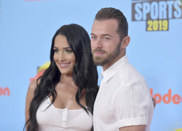 man and woman appear on red carpet