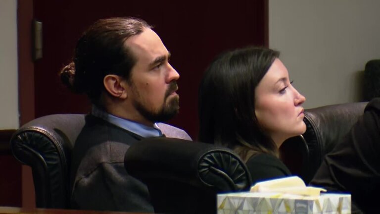 man sits in courtroom