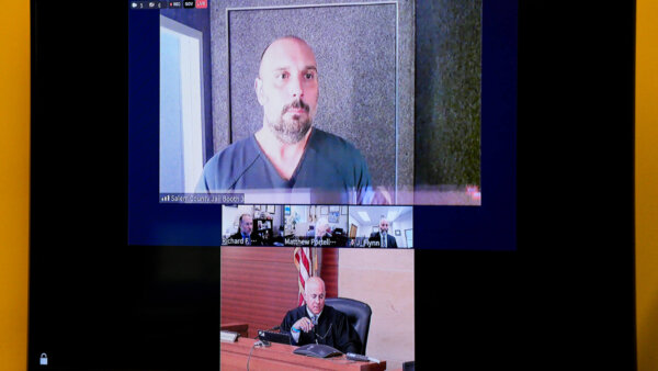 Sean Higgins and a judge are shown on a zoom screen in court