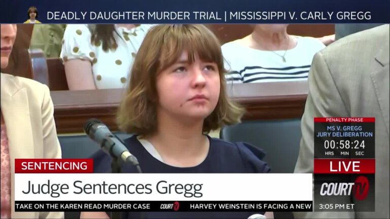 young teenage girl looks up as she's sentenced.