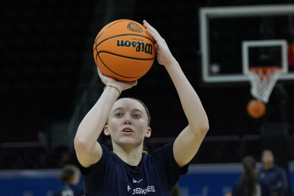 woman throws basketball