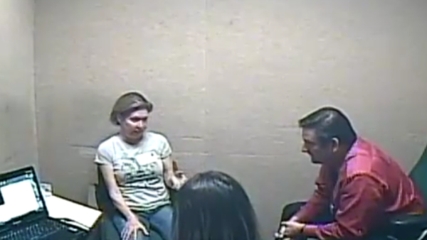 A woman speaks to a man and a woman in an interrogation