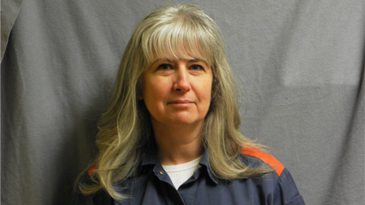 Mug shot of a grey-haired woman