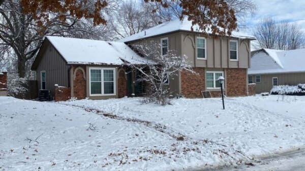 House with snow in yard