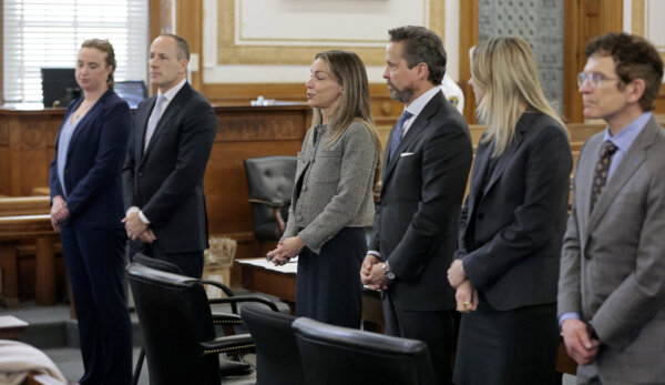 Karen Read, third left, and her defense team, Victoria George, from left, David Yannetti, Read, Alan Jackson, Elizabeth Little, and Robert Alessi