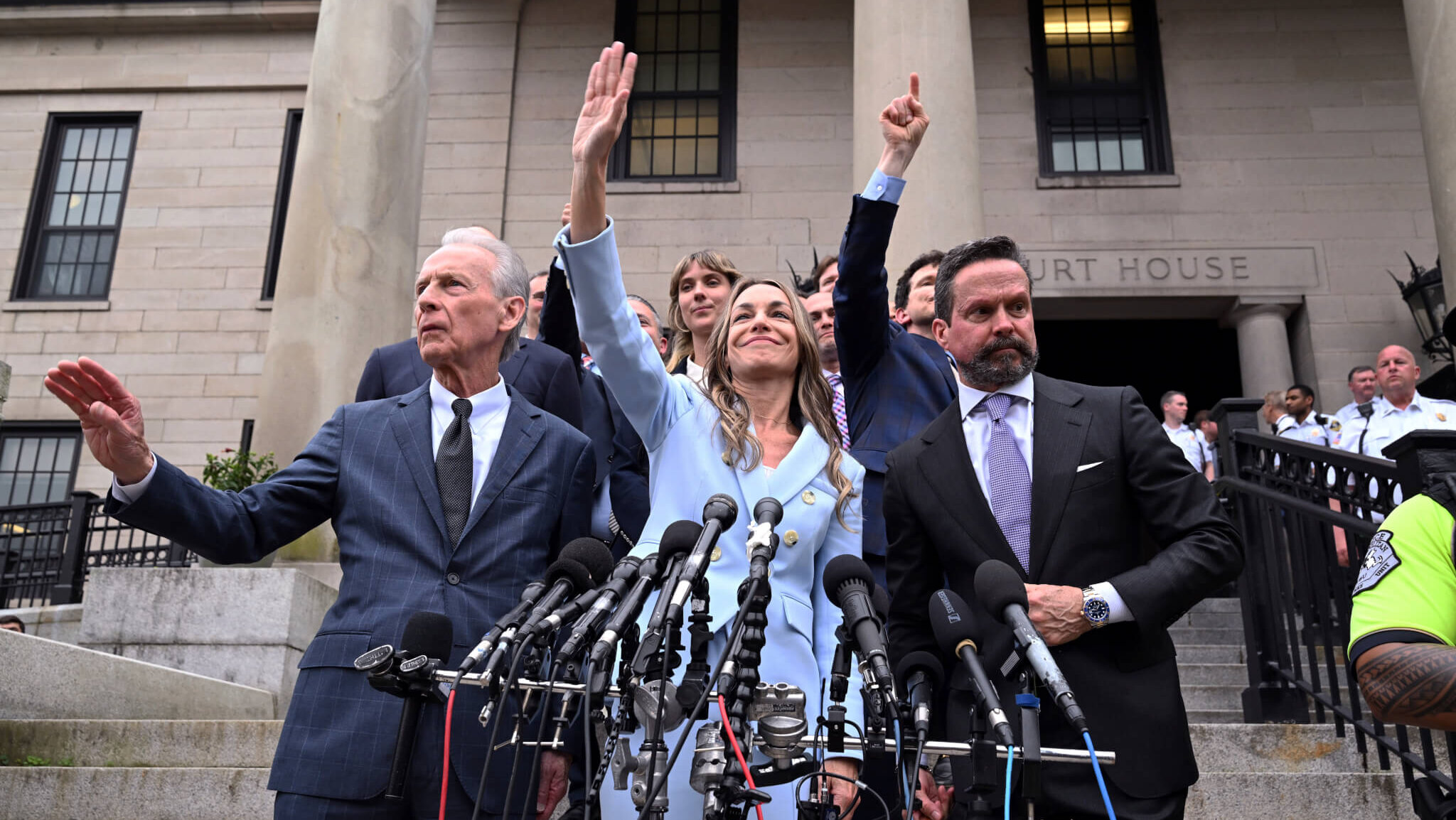 Karen Read, center, waves to supporters