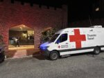 American Red Cross Disaster Relief van is parked outside a hotel