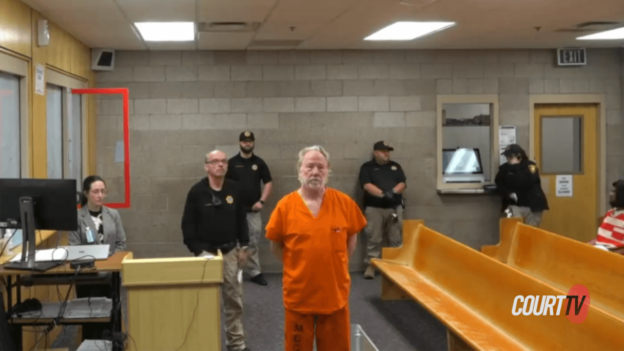 man in orange jumpsuit in court