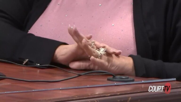 Woman's hands seen on a table.