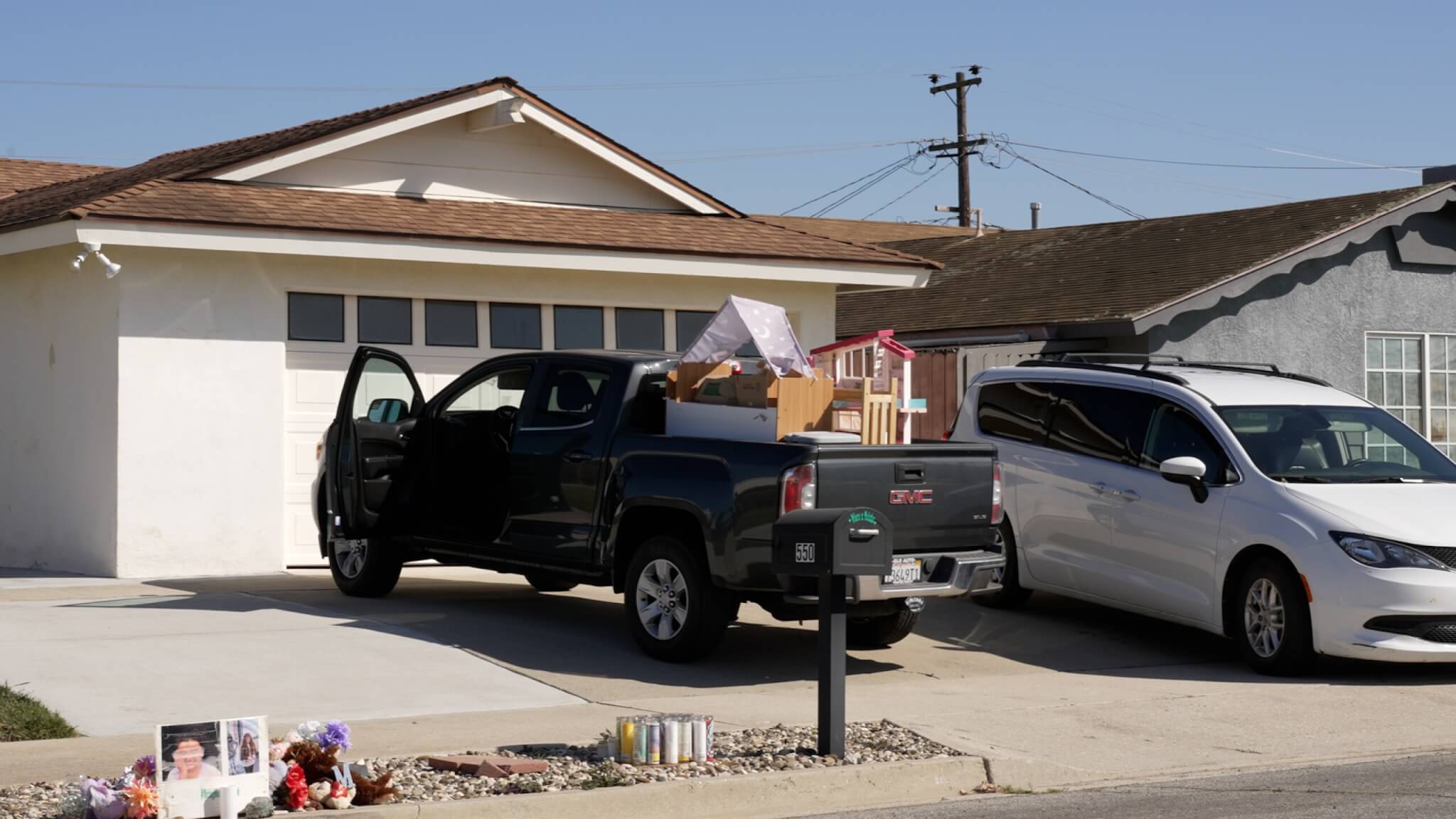pickup truck packed with belongings in driveway outside house