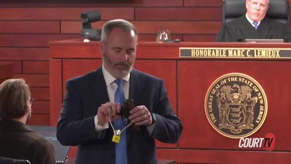 Prosecutor holds gun in court