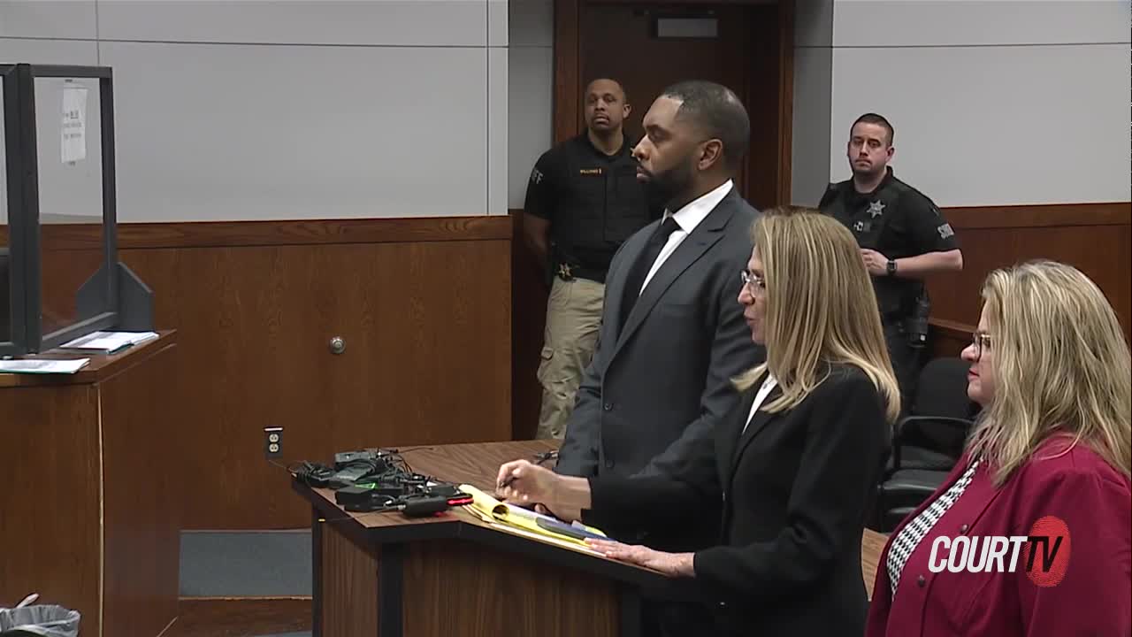 Sherrone Moore stands in court