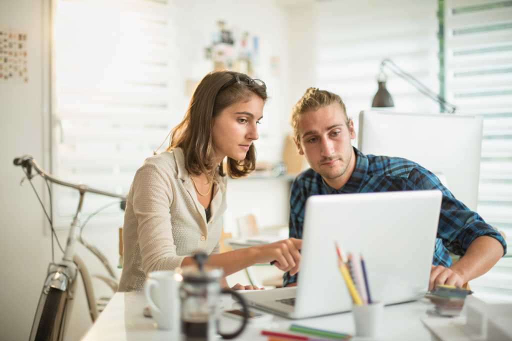 two coworkers looking and planning email marketing