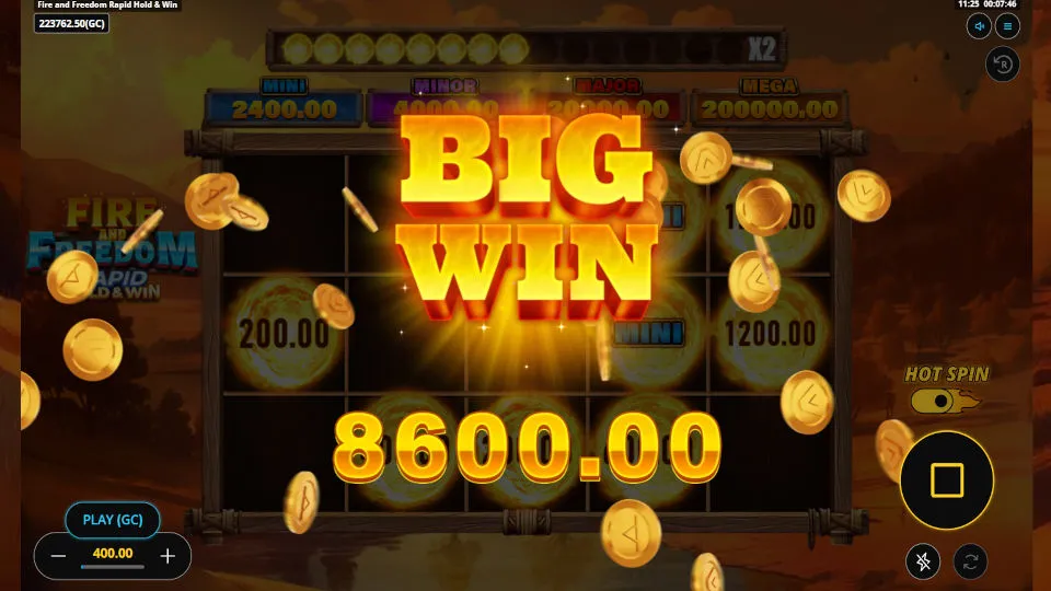 Big win screen from the Fire and Freedom Hold and Win slot shows an 8,600 GC win with falling coins.