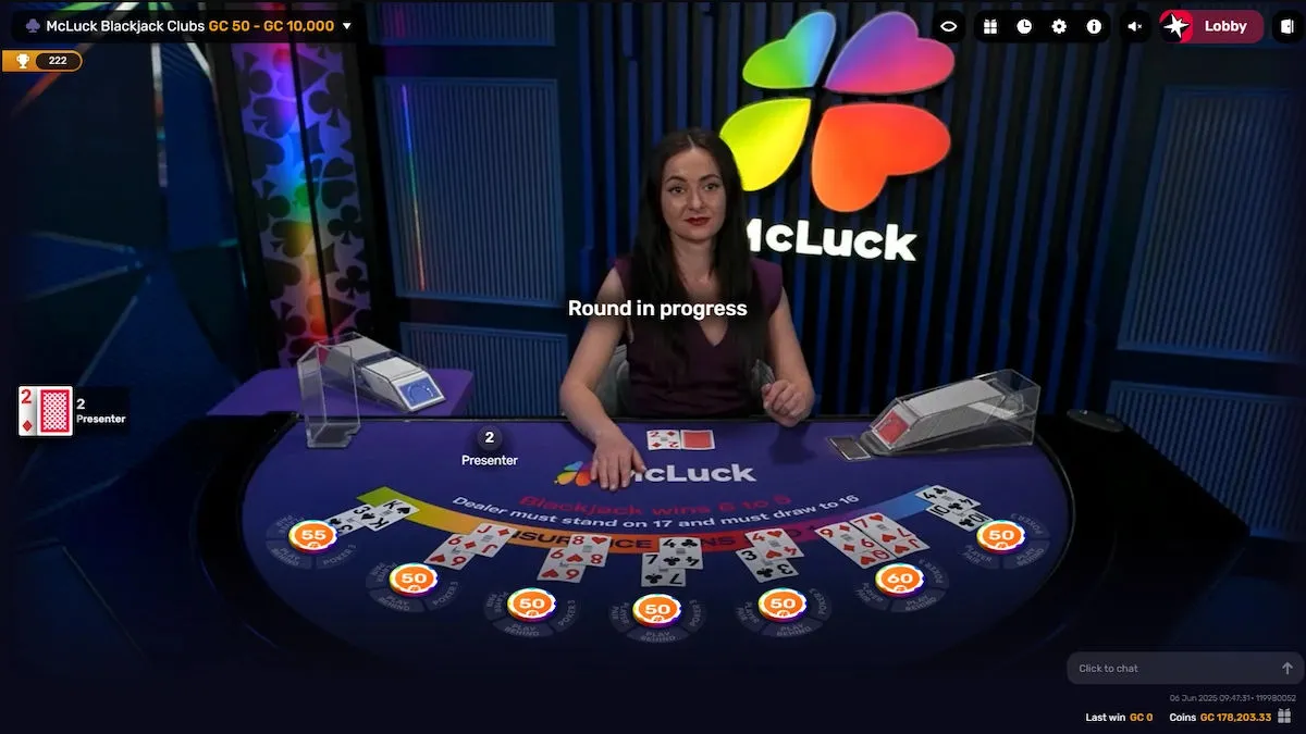 Round in progress at McLuck Blackjack Clubs with multiple hands on the table, dealer holding cards, and McLuck branding in the background.