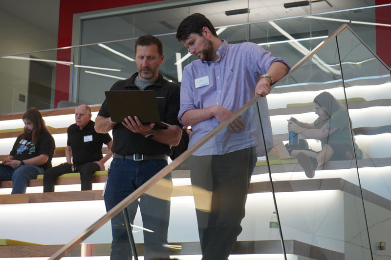 IMT employees reviewing project on laptop