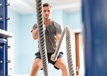 A guest works out inside The Breakers Ocean Fitness center 