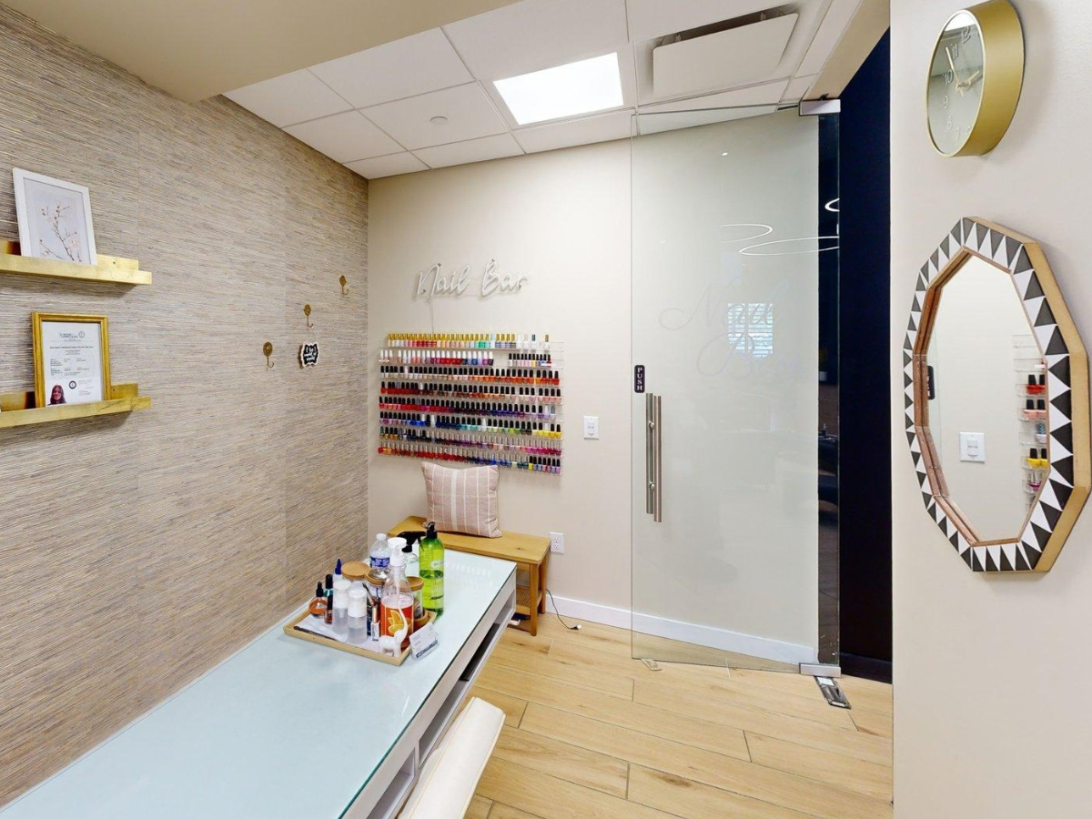 The nail bar at Mercedes-Benz of Fort Mitchell, with a manicure station and a wall display of polish colors