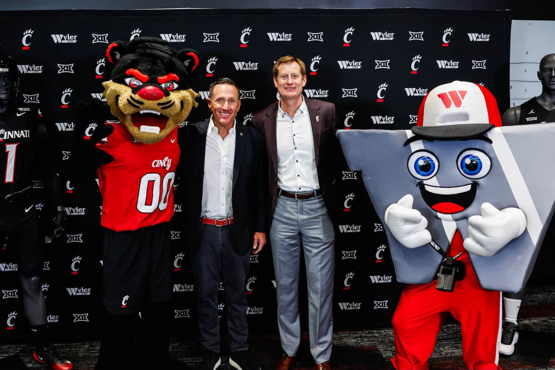 Wyler and University of Cincinnati leadership at the announcement backdrop
